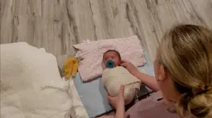 Jackie posing a newborn baby at her studio in Cincinnati